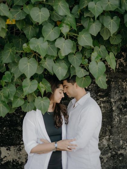 Another beautiful shot under the canopy of leaves. The way the leaves frame their faces draws all the attention to their close, emotional connection.