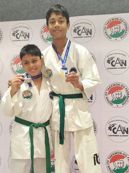 Two brothers in sport, proudly showing their medals from the national championship. We foster a supportive environment for all our students.