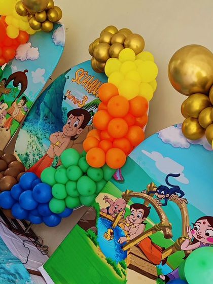 A close-up of a Chhota Bheem-themed backdrop, showing the colorful characters and balloon details.