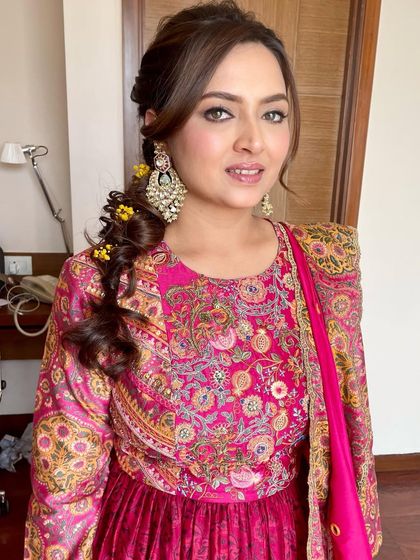 A close-up of the Mehendi makeup. The focus is on the beautifully defined eyes, which make a statement against the colorful outfit.