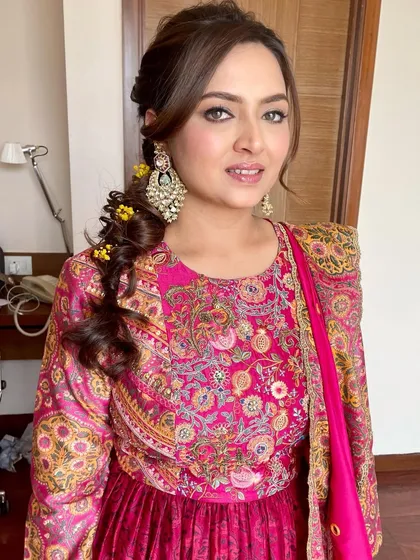 A close-up of the Mehendi makeup. The focus is on the beautifully defined eyes, which make a statement against the colorful outfit.