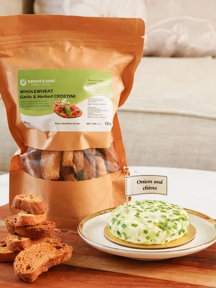 Wholewheat garlic and herbed crostini paired with the cheese spread, offering another delicious serving suggestion.