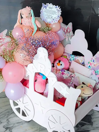 Another view of the magnificent pink chariot hamper, showcasing its scale and the abundance of gifts and decorations it holds.