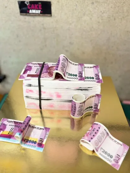 A cake designed to look like a stack of Indian 2000 rupee notes. The edible paper and realistic details make this a very unique and talked-about cake.