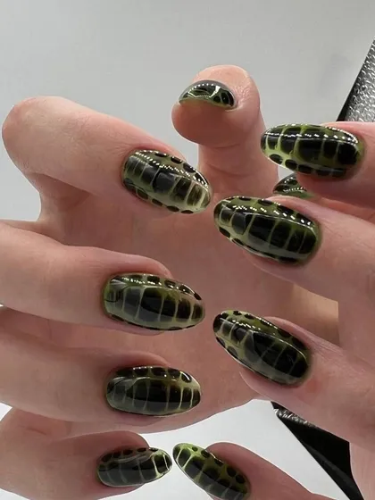 A unique green crocodile skin effect, demonstrating the creative possibilities with this fun and trendy nail art technique.