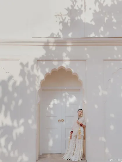 Using architecture to frame a bridal portrait. The clean white walls and the shadows of the leaves create a beautiful, high-contrast backdrop for Sejal's elegant pose, making it a simple yet striking image.