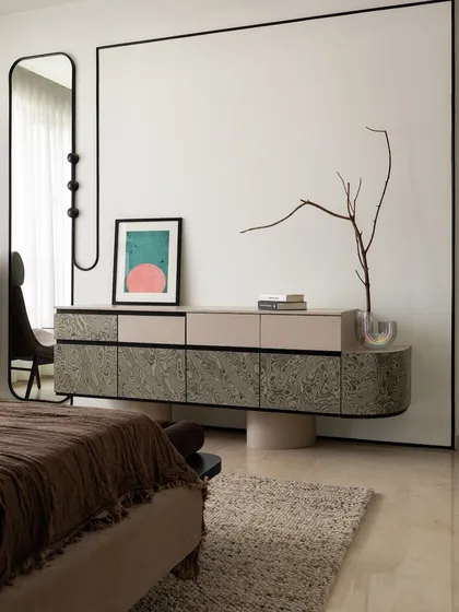 The custom floating console in the master bedroom, paired with a full-length mirror and curated art. This setup maximizes floor space while providing ample storage and a touch of elegance.