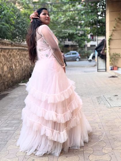 The flowing layers of this pink gown create beautiful movement, making it perfect for photos and videos.