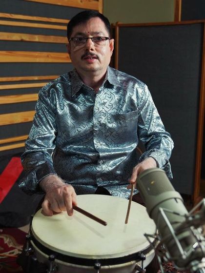 A folk percussionist from the Bangalore rhythm section. His unique instrument adds a distinct texture to the album's sound.