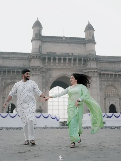 From serene landscapes to iconic cityscapes like Mumbai's Gateway of India, I capture your story wherever it unfolds. This shot shows a candid, windswept moment against a famous backdrop.