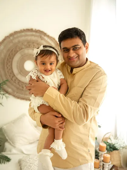 A proud father holds his one-year-old daughter. I always make sure to capture individual portraits of parents with their children during a family session to highlight each unique bond.