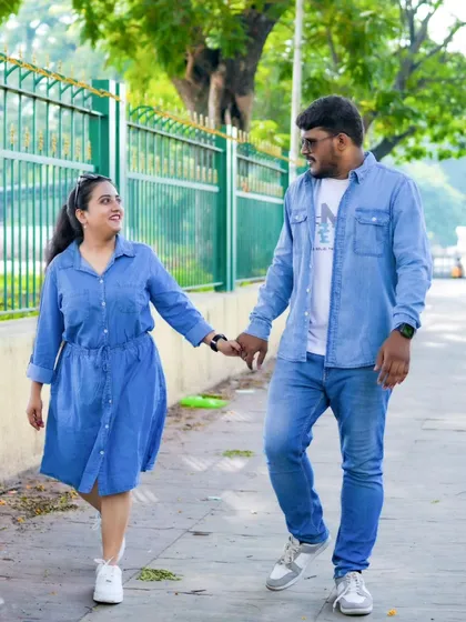 A happy walk in the park. The couple's matching denim outfits create a coordinated and stylish casual look for their pre-wedding shoot.