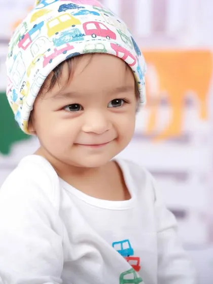 A sweet, gentle smile from our mini artist. This close-up captures the quiet, happy moments during our creative and colorful paint-themed session.