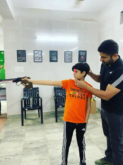 Every champion starts with the basics. Here, I am providing one on one instruction to a young shooter, correcting his stance and grip for the air pistol. I believe in building a strong technical foundation for shooters of all ages.