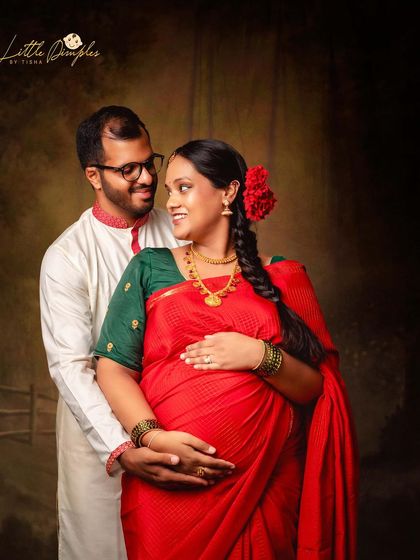 The way they look at each other says it all. A classic couple's portrait from a traditional saree maternity session, filled with love and anticipation.