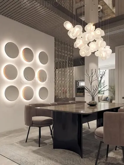 The dining area in the DLF home, featuring a stunning cloud-like chandelier and a wall of backlit circular mirrors that act as a large-scale art installation.
