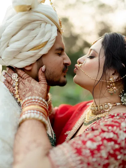 An intimate close-up of the bride giving the groom a playful and affectionate kiss. This shot is all about the small, tender gestures that speak volumes, capturing the deep connection and love between the couple on their wedding day.