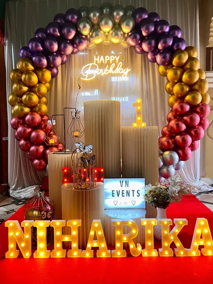 Another look at Niharika's colorful birthday setup. The red carpet and white curtain backdrop complete the look for a grand celebration.