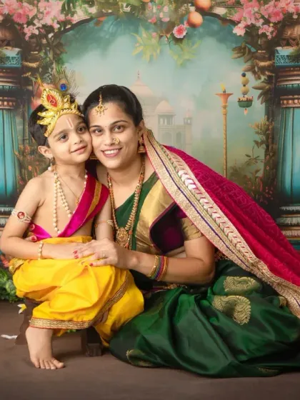 A classic seated portrait of mother and son in our Krishna-themed setup. The composition is designed to feel like a timeless painting you can cherish forever.