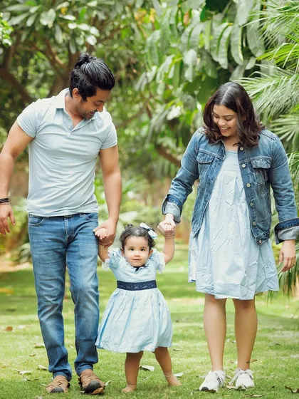 A lovely family stroll through the park. The coordinated denim and blue outfits look wonderful against the green backdrop.