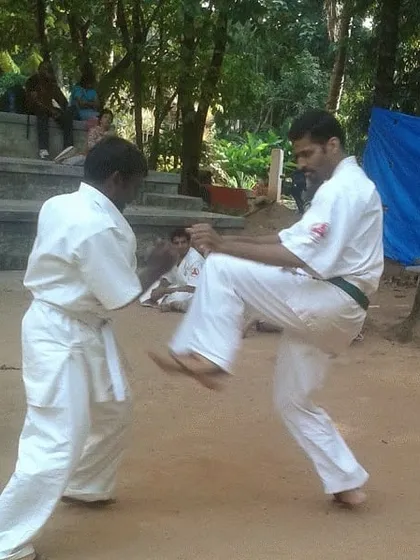 Outdoor sparring practice. Training on different surfaces like dirt improves footwork and adaptability.