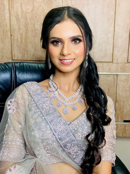 A close-up portrait of the client from the engagement makeup transformation. Her smile shows her happiness with the final look.