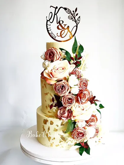 For moments that call for sheer elegance, this three-tier wedding cake is a perfect choice. This 6kg Belgian chocolate truffle cake features a cascade of dusty rose and cream flowers, creating a timeless centerpiece for a couple's special day.