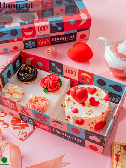 My Valentine's Day gift box is perfect for sharing. It includes a heart-themed pineapple bento cake and four matching assorted cupcakes, all presented in a beautiful clear-lid box.