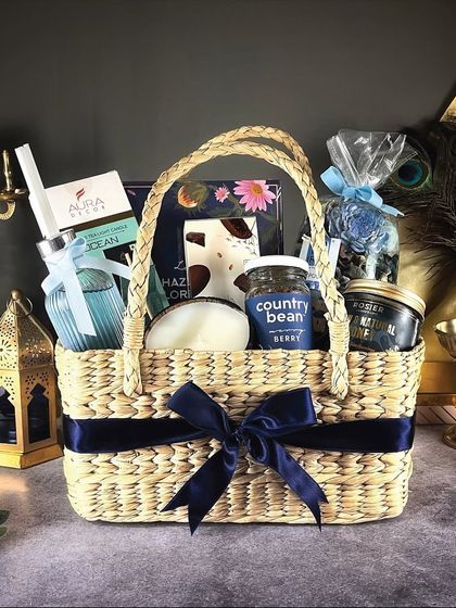 Our "Grand Galore" hamper is a luxurious basket filled with blue-themed items, including a diffuser, gourmet coffee, and premium chocolates.
