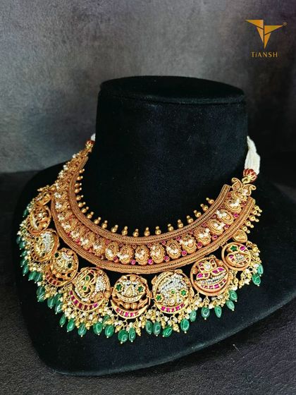 The 'after' of the transformation. The original gold necklace is now a grand, contemporary piece adorned with Basra pearls, rubies, and emeralds, completely reimagined while preserving its soul.