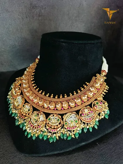 The 'after' of the transformation. The original gold necklace is now a grand, contemporary piece adorned with Basra pearls, rubies, and emeralds, completely reimagined while preserving its soul.
