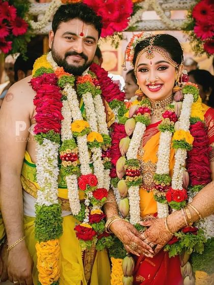 Congratulations to this beautiful couple. The bride is glowing in her traditional yellow and red muhurtham saree, with makeup that enhances her natural beauty and happiness.