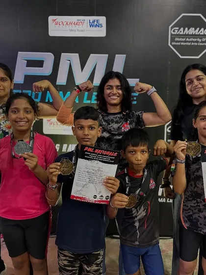 Our girl power on full display. Young female fighters flexing with their medals after the PML National MMA Championship. We empower girls with strength, confidence, and self-defense skills.