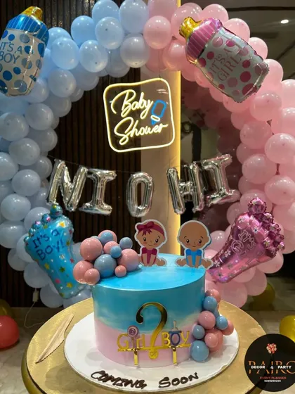 A perfect setup for a baby shower or gender reveal party. This design features a full balloon ring in pink and blue, a custom "Baby Shower" neon sign, and a matching cake, creating a beautiful focal point for the celebration.