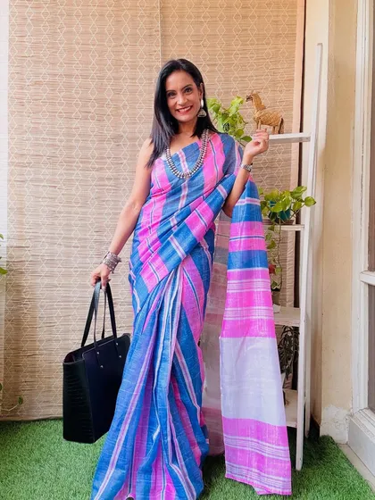 A vibrant pink and blue striped pre-stitched cotton saree. This is a cheerful and colorful option for a busy day when you want to wear a saree without the fuss.