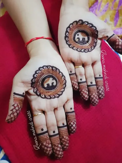 A cute and minimalist design featuring elephant mandalas in the center of each palm. The fingers have simple bands and dotted tips, making this a quick and charming choice.