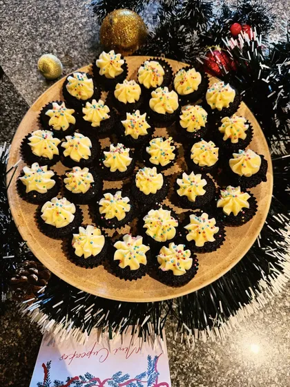 Mini chocolate cupcakes with a swirl of buttercream frosting and colourful sprinkles. These were part of a large Christmas catering order for a corporate client.