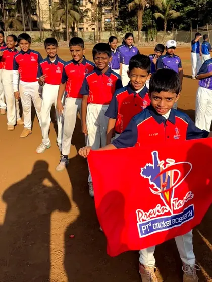 The U-10 Red Team, holding their flag and ready to play. We focus on fun and fundamentals at this age.
