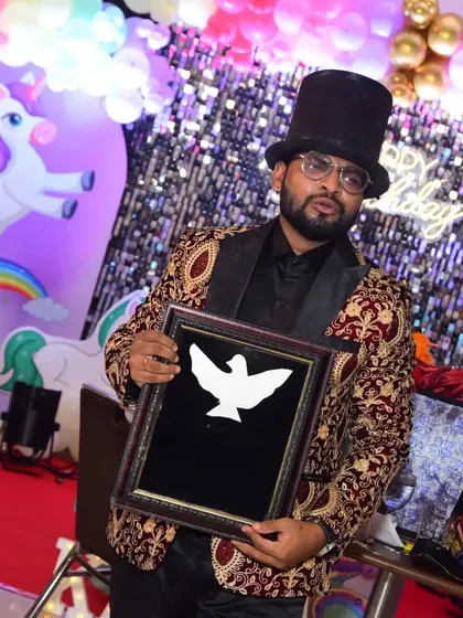 Presenting the dove frame illusion. This is the moment before the magic happens, building anticipation in the audience.
