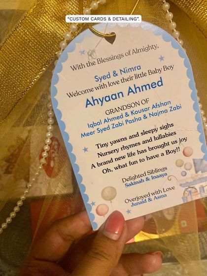 A close-up of the custom card for baby Ahyaan Ahmed's naming ceremony. These personalized notes are what make each gift a true storyteller.
