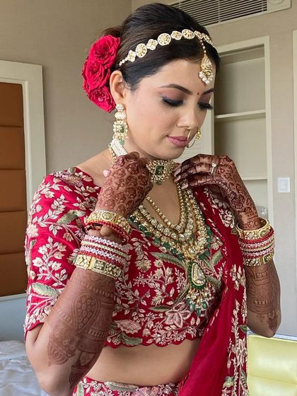 A final look at the stunning bride with her red rose updo, ready for her big day.