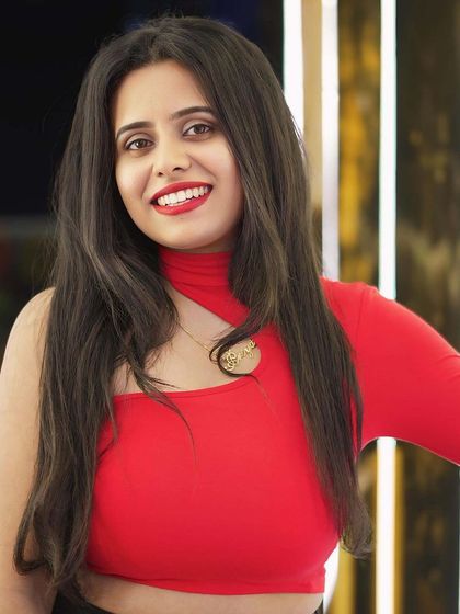 A guest in a vibrant red top, looking happy and confident.