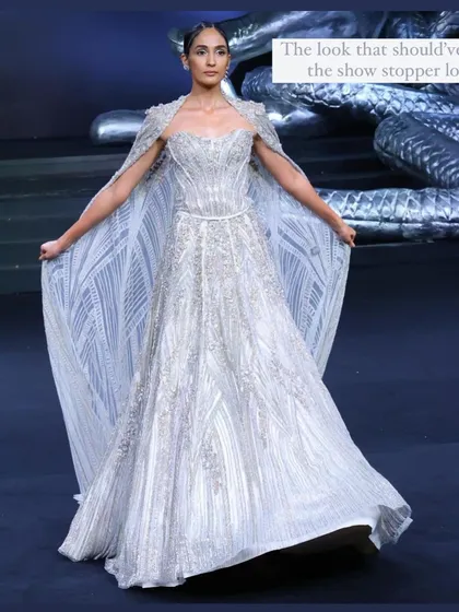My personal favorite from the Gaurav Gupta show. This stunning silver-white gown with a dramatic cape should have been the showstopper. A perfect reception look.