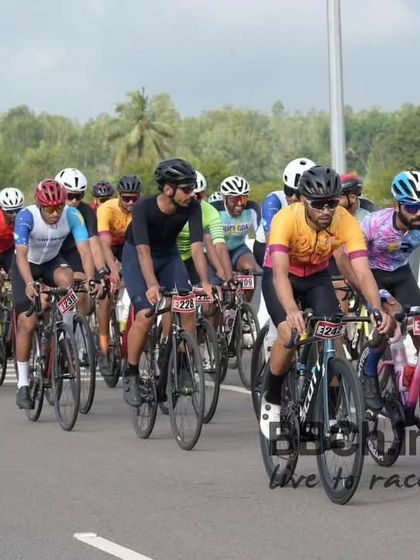 A group of masters riders, with palm trees lining the road, enjoy the scenic route of the Nandi Epic.