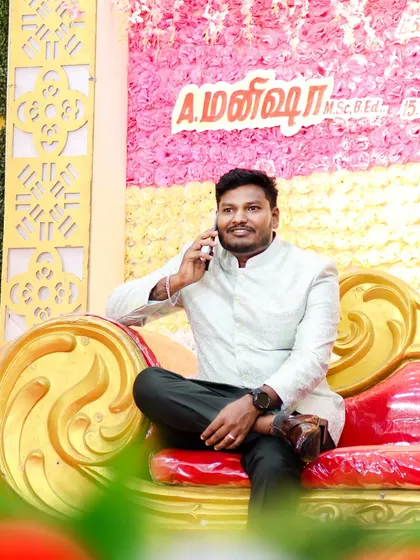 A candid shot of the groom looking relaxed and stylish during the wedding festivities. Capturing these in-between moments shows the groom's personality beyond the formal poses.