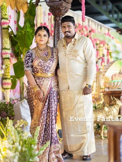 A portrait of the proud parents amidst the decor. The soft lighting and layers of flowers and brass create a warm and flattering environment, perfect for capturing family portraits that will be cherished for years.