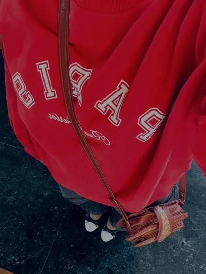 A top-down shot of a cozy red GAP sweatshirt and jeans, a classic casual look.
