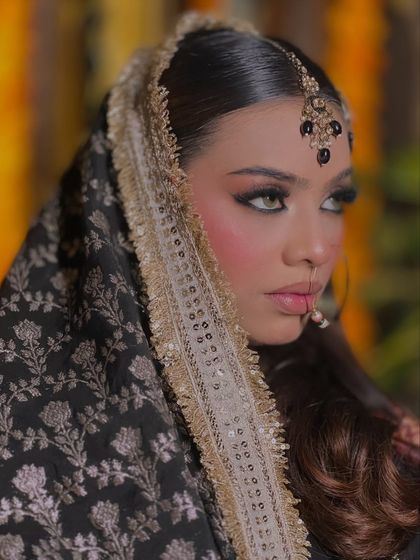 A striking portrait that highlights the intense and mesmerizing eye makeup. This look is perfect for a traditional Pakistani bridal style.