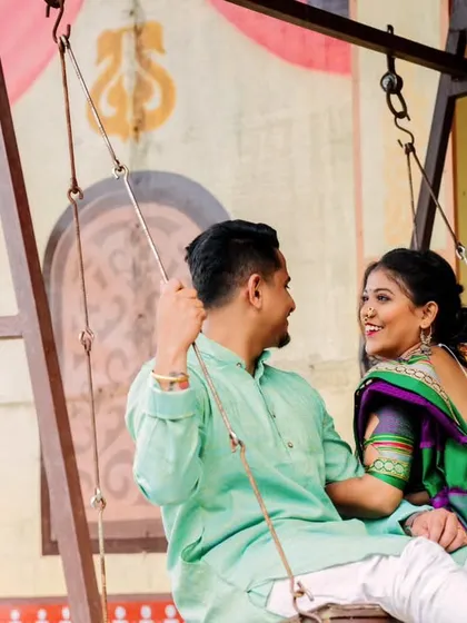 A playful and happy moment on the swing. This candid shot captures their joyful interaction, bringing life and energy to this traditional pre-wedding photoshoot.
