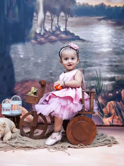 A princess in her wooden carriage. This simple and sweet setup is perfect for capturing the innocent charm of a sitting baby.